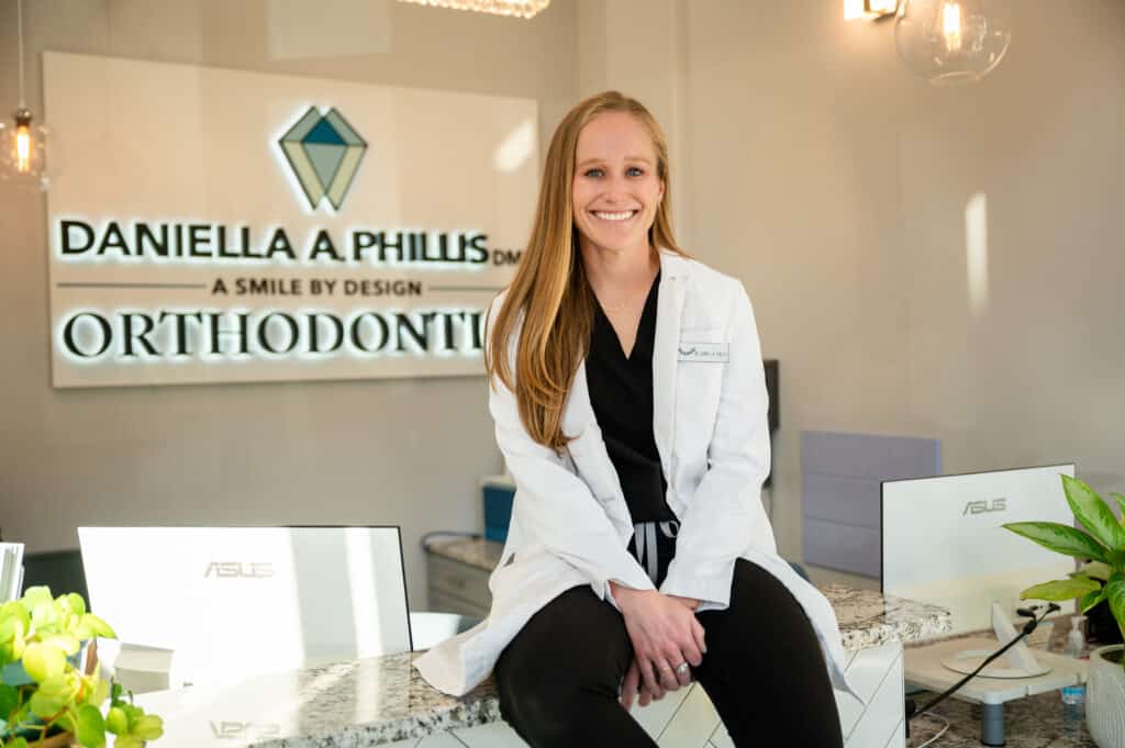Dr. Daniella Phillis seated in office reception area at Smile By Design Orthodontics in Durango, Cortez, and Pagosa Springs, CO
