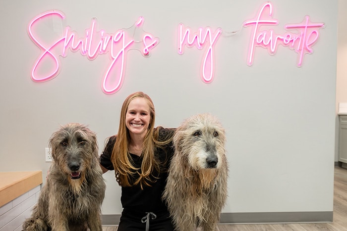 Dr. Daniella Phillis with two dogs in office at Smile By Design Orthodontics in Durango, Cortez, and Pagosa Springs, CO